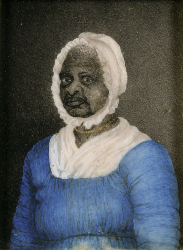 A miniature watercolor portrait of a elderly African American woman, Elizabeth Freeman (“Mumbet”), wearing a white cap, a blue dress with a white fichu tucked into the neckline, and a gold beaded necklace.