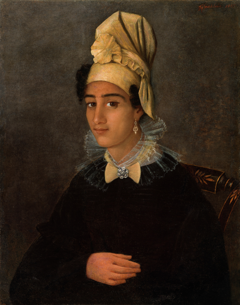 An 1837 oil painting of a young Black woman dressed in a dark top, wearing a delicate tiered lace collar, a brooch, dangling earrings, and a golden headscarf or tignon with a rosette and exposed curls above both ears.